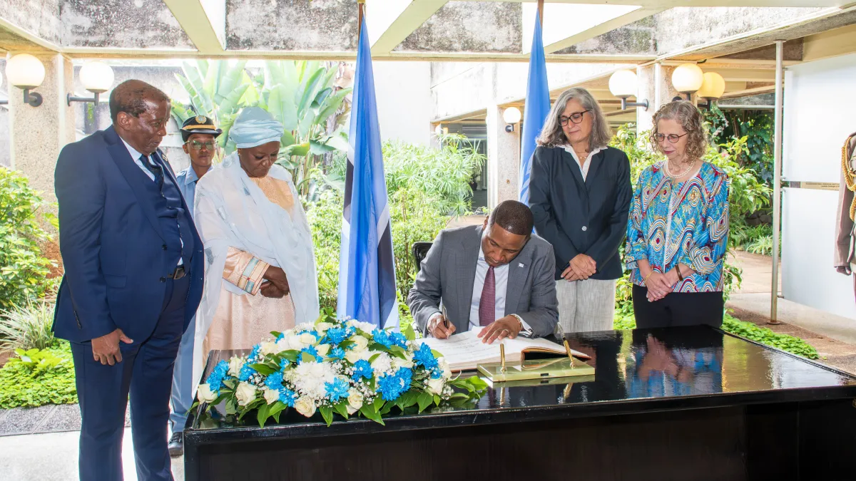 The President of the Republic of Botswana signing the Visitors Welcome book