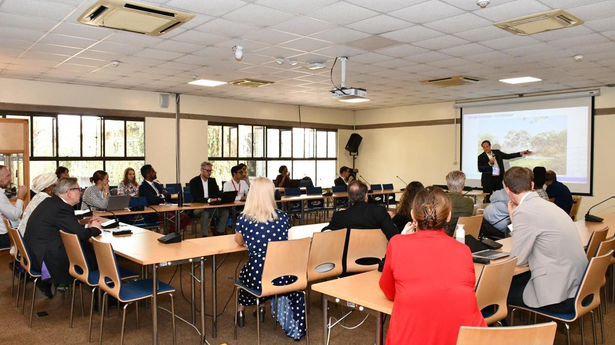 Members of the WEOG attending a presentation in a conference room