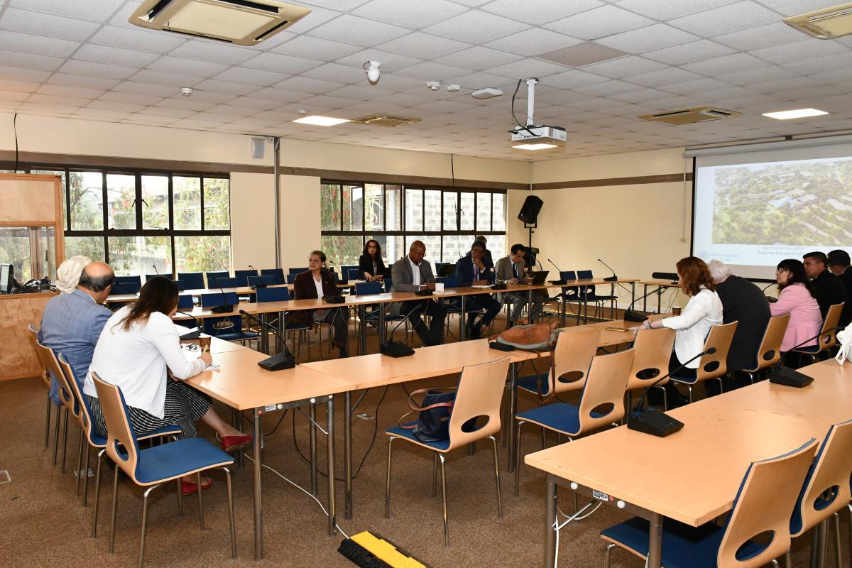 Members of the GRULAC attending a presentation in a conference room