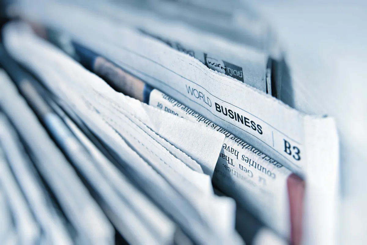 Close-up image of newspapers symbolizing news, media coverage, and global business reporting